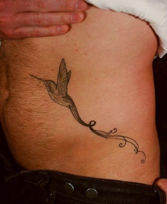 Hummingbird Flying Pic Tattoo On Side Stomach